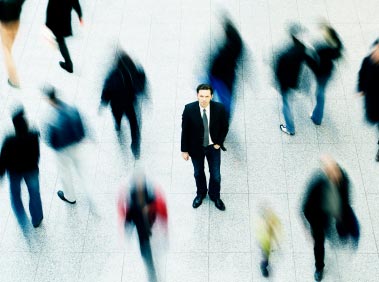 Man standing on his own in a crowd, suffering from anxiety and Panic